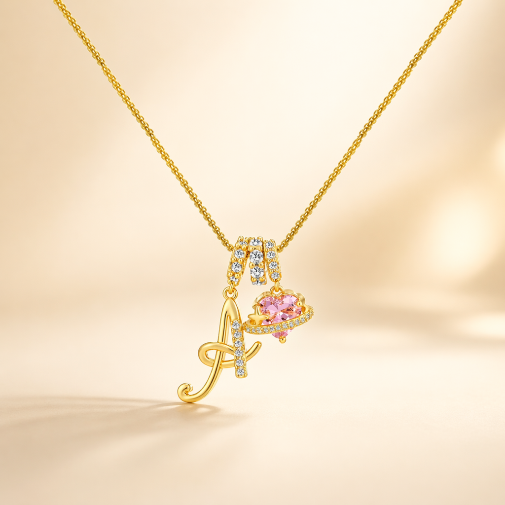 Our Collection gold initial necklace with pink heart charm
